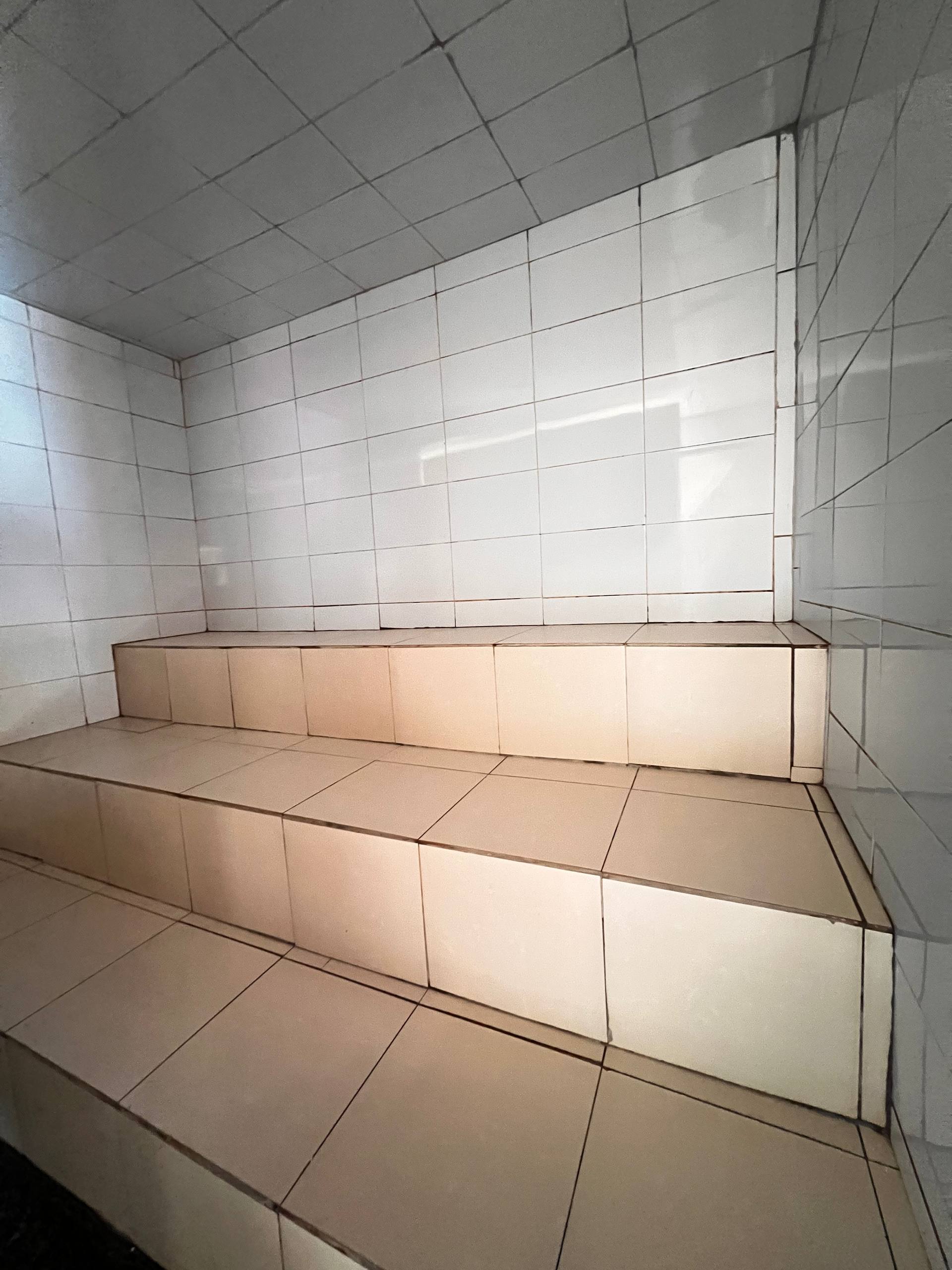 Tiled seating inside Eden steam room